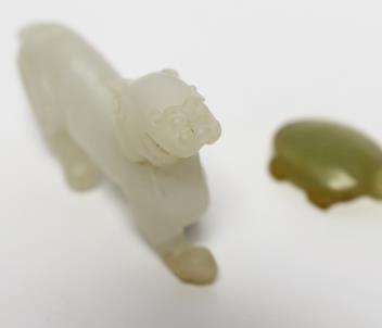 A 19th century Chinese jade model of a lion-dog, 9cm, together with a hardstone ‘tortoise’ pendant